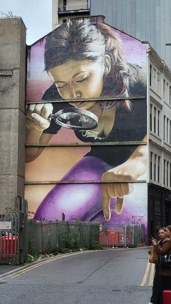 Mural of a girl with a magnifying glass
